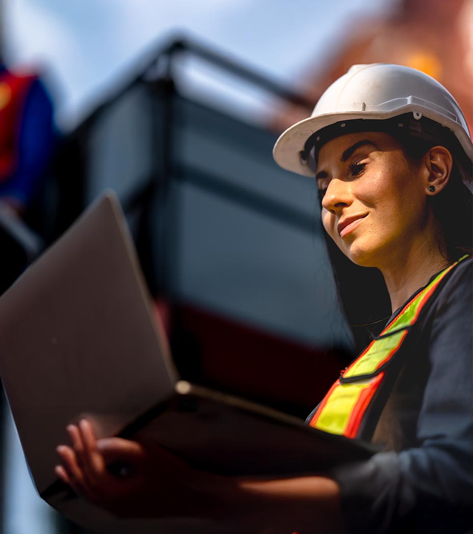 Woman in a construction site working on her laptop