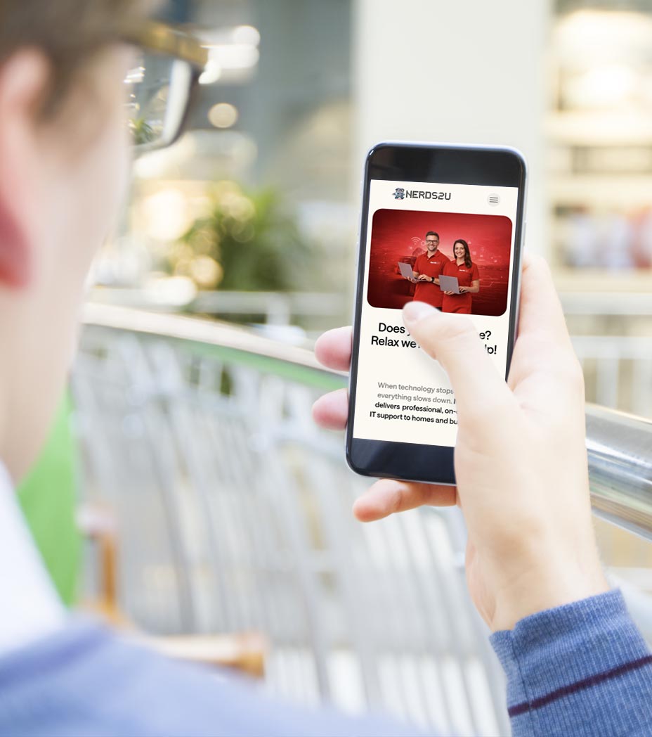 A man with his a phone on Nerds2U website